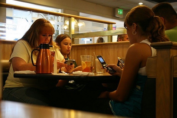 Family eating dinner and cell phones