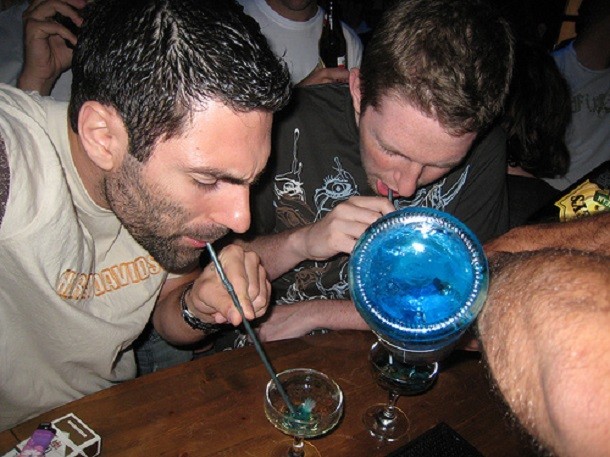 Guys playing drinking game