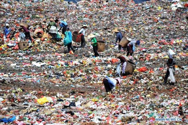 Scavengers look for recyclable things at a trash dump in Nanning in southern China