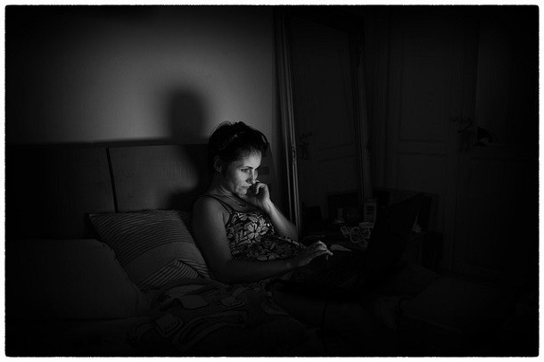 woman on computer in bed