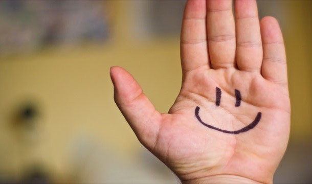 Smiley face on hand
