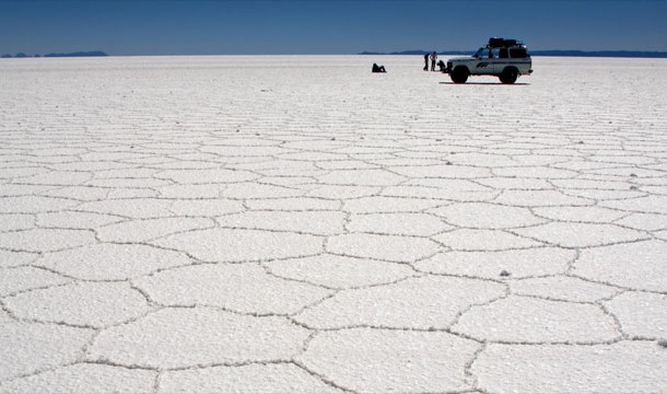 Cruising across the world's largest salt flat , the Salar de Uyuni in Bolivia