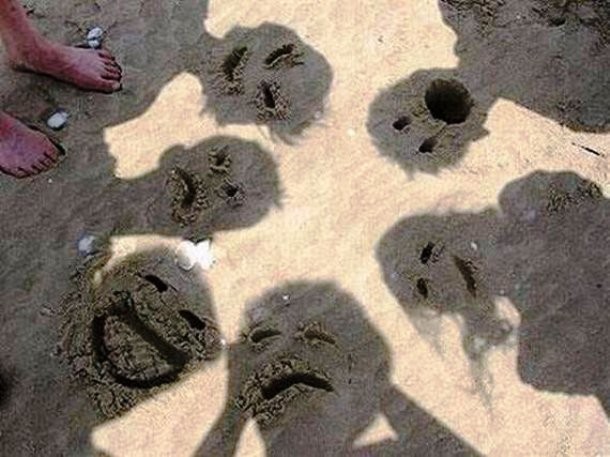 faces in sand