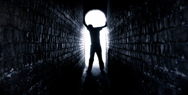 A person standing in a tunnel