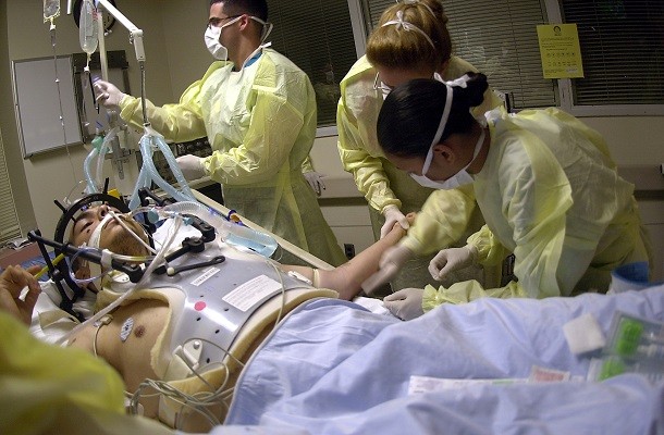 Navy Hospital Corpsmen and Medical Officers assess the treatment and prognosis of a patient with a gunshot wound to the head in the Intensive Care Unit (ICU) at the Los Angeles County, University of Southern California (USC) Medical Center. The students are part of an outreach cooperative training program between Navy Medicine and the medical center. The Naval Trauma Training CenterÕs (NTTC) mission is to provide trauma experience and knowledge to Naval medical personnel before they deploy. The students from Naval Hospitals, clinics and commands at Naval Installations around the world, work in the emergency room, operating room and intensive care unit, to learn about the wide range of situations they may encounter when sent into the field. U.S. Navy photo by PhotographerÕs Mate 2nd Class Johansen Laurel (RELEASED)