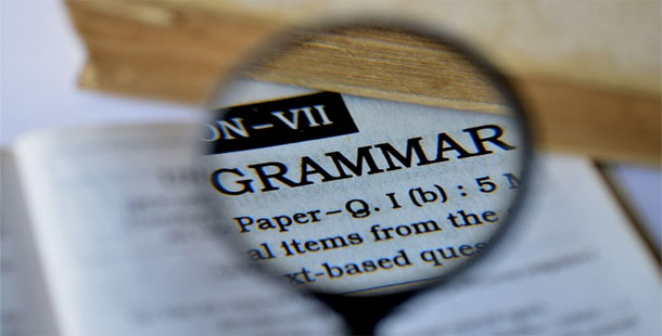 A magnifying glass over a page of a grammar