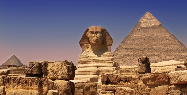 A close-up of a sphinx and pyramids