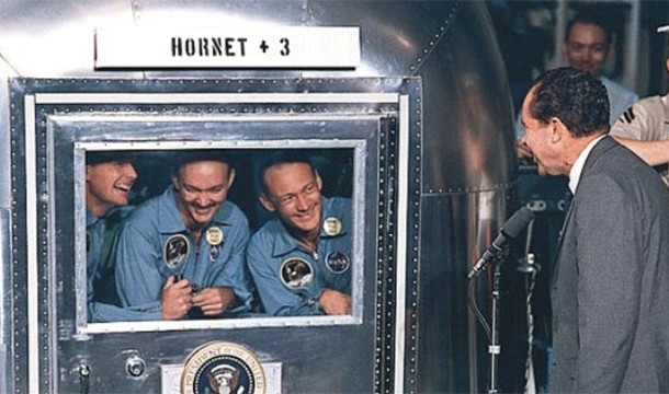 President Nixon greets the crew of Apollo 11 upon their return to Earth while they are in quarantine aboard a recovery ship (1969)