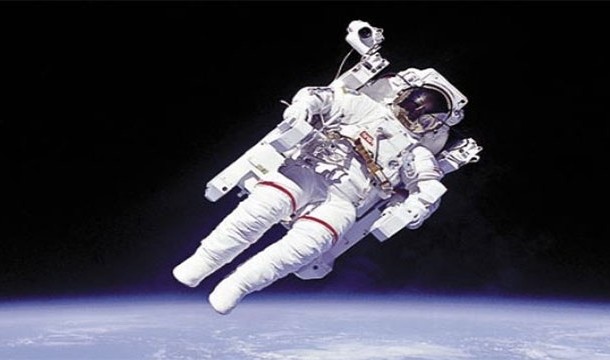 Bruce McCandless II ventures more than 300 feet away from the shuttle using a jet powered pack. This was the first untethered spacewalk (1984)
