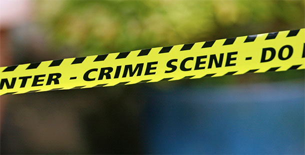 A close-up of a crime scene with yellow and black tape