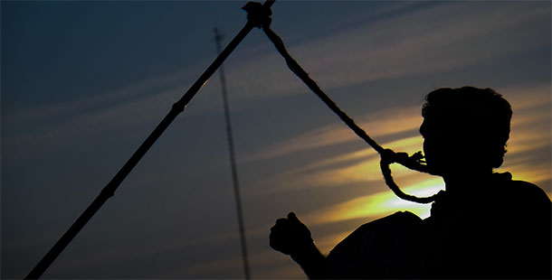 A silhouette of a person holding a rope