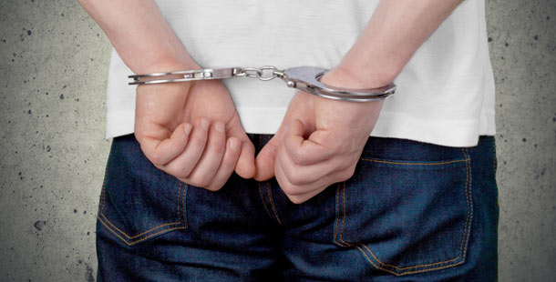 A person in handcuffs behind their back