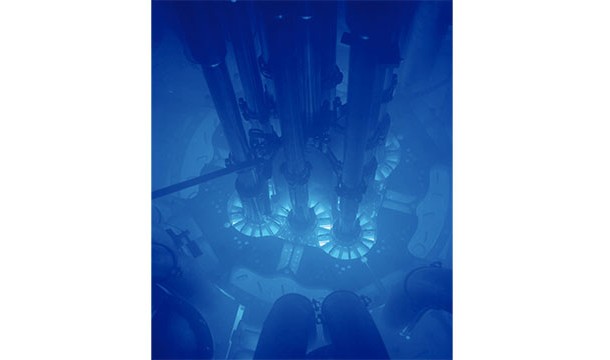Cherenkov radiation is what happens when a particle travels through a medium (like water) faster than light would. This radiation gives off a blue glow that is characteristic of underwater nuclear reactors