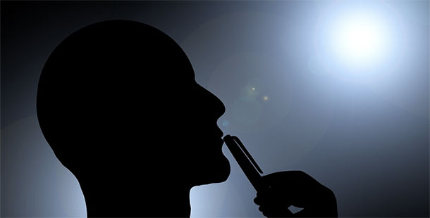A silhouette of a person using a phone