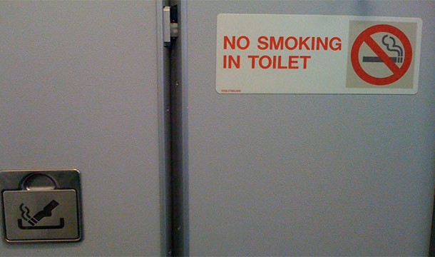 There is a small latch inside the lavatory sign that will open the door when it is pulled, even if the door is locked.