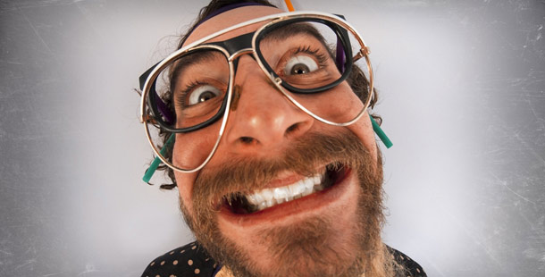 A person with a beard and mustache wearing glasses