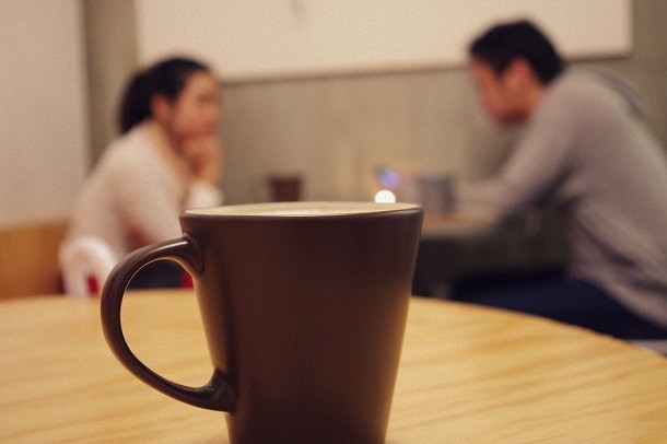 Conversation with coffee in foreground