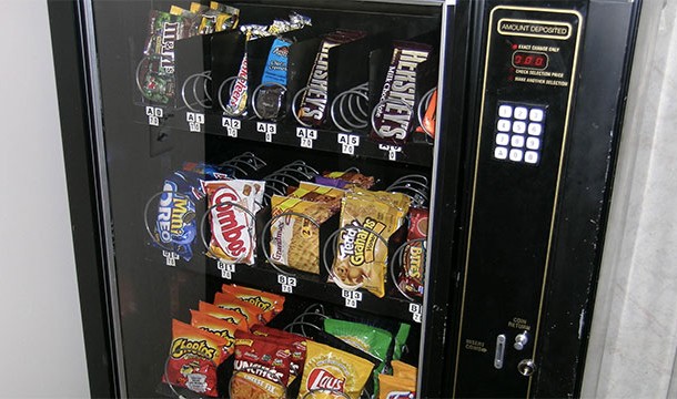 Putting a dollar in the vending machine