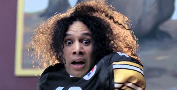 A person with long curly hair wearing a football jersey