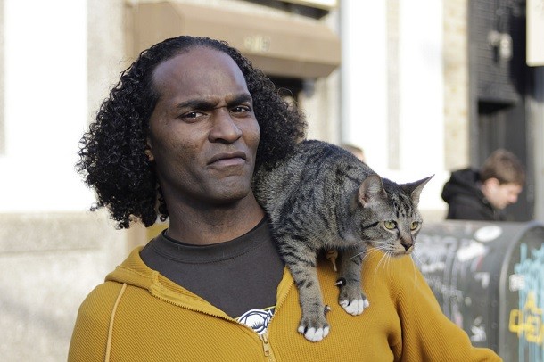 man with shoulder cat