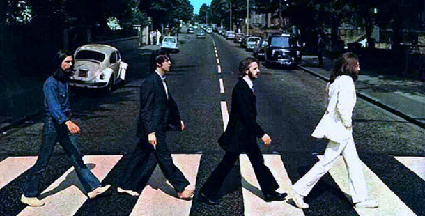 A remarkable group of beatles crossing a street