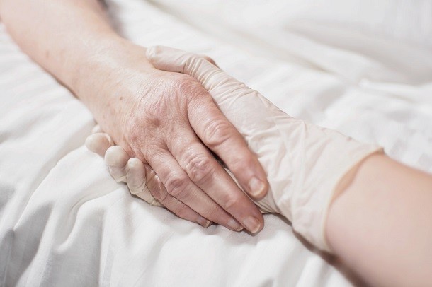 hands holding in hospital