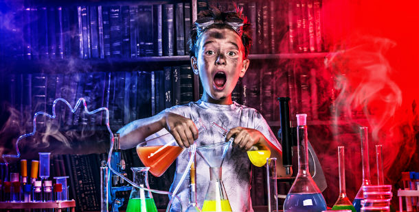 A biggest scientific discovery with child holding a beaker with liquid in it