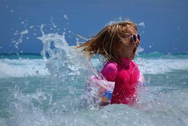 girl playing in ocean