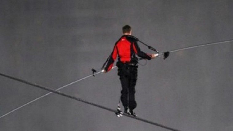 A person walking on a tightrope, unbelievable feats of humans
