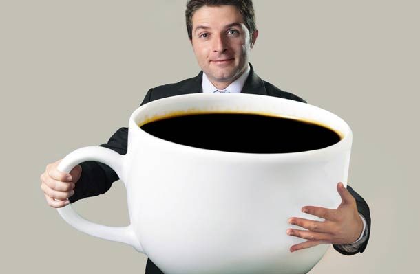 man holding large coffee cup