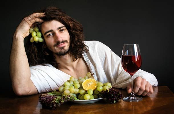 man with grapes and wine