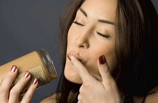 Woman eating peanut butter