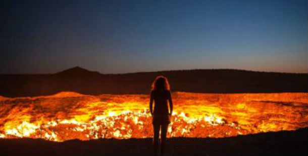 A person standing in front of a volcano