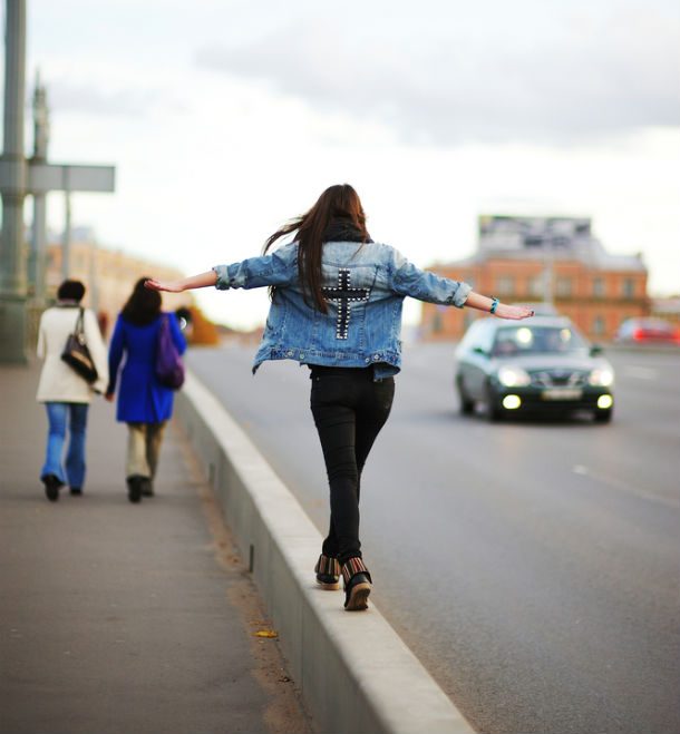 woman walking on curb