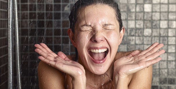 A person laughing in the shower