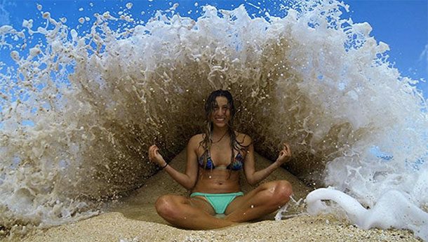 wave crashing over woman at the beach