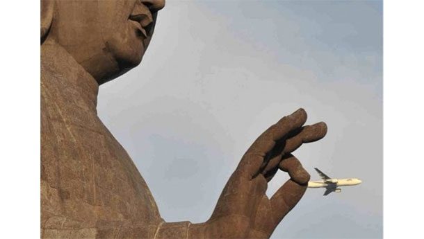 statue grabbing an airplane