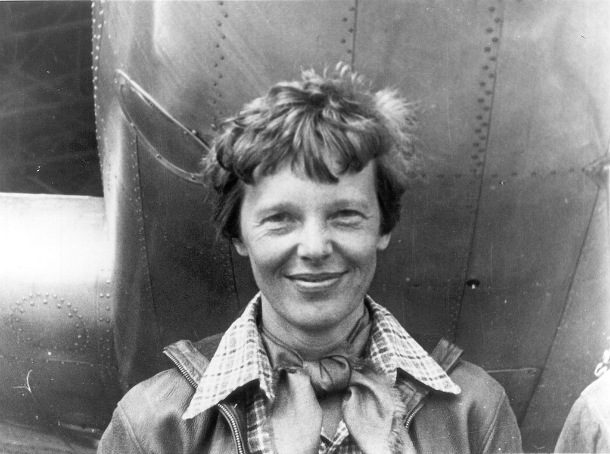 Amelia_Earhart_standing_under_nose_of_her_Lockheed_Model_10-E_Electra_small