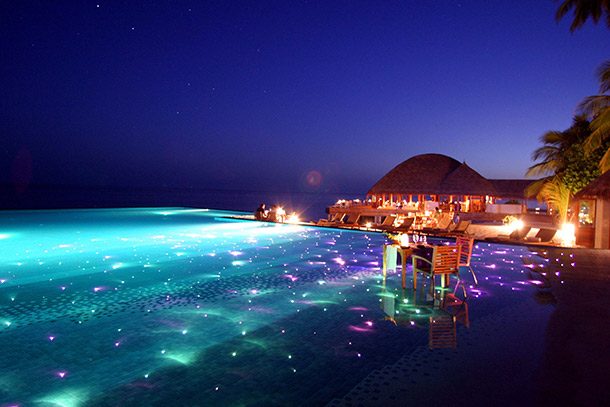 Infinity-Pool-with-dining-and-LED-lights-Huvafen-Fushi-Resort-in-Maldives