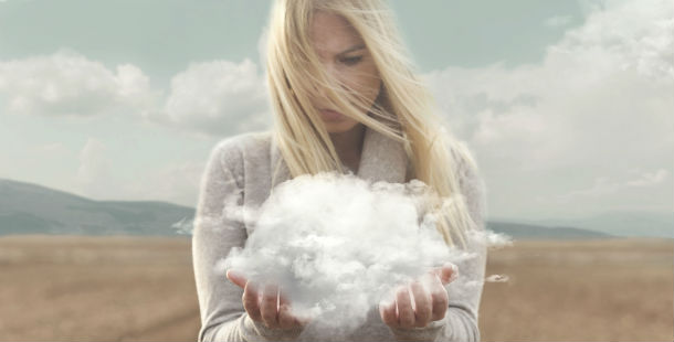 A person dreaming holding a cloud