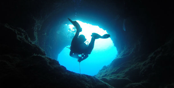 A person diving in a cave