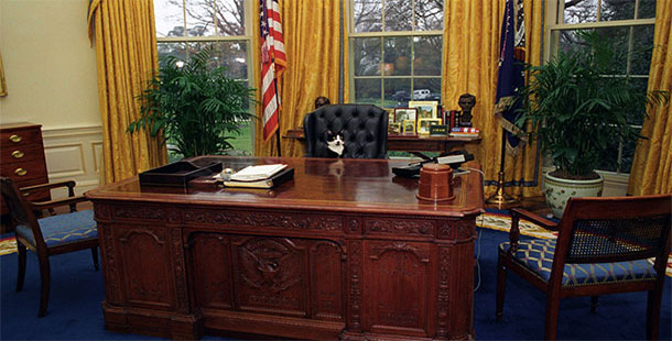 A desk with a chair and a flag, facts about oval office