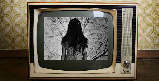 A person in a dress on a television