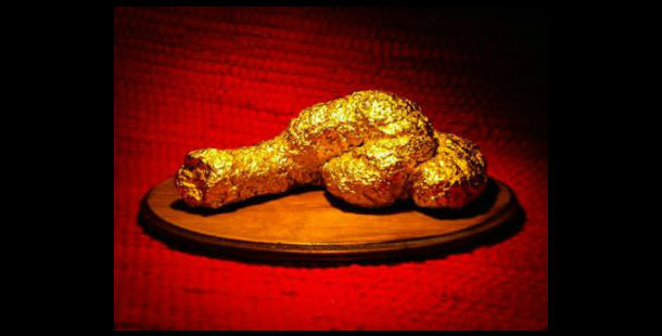 A gold object on a wooden plate