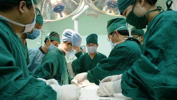 surgeons operating patient