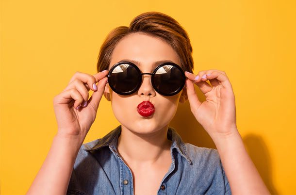 Girl with glasses blowing a kiss
