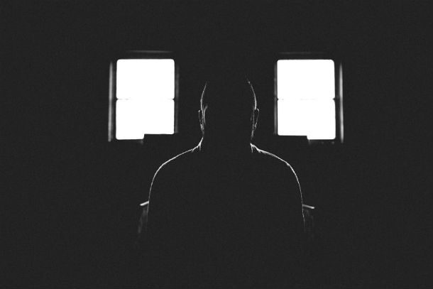 man sitting in dark room