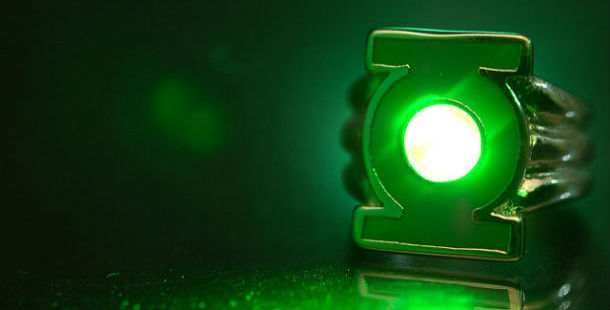 A ring with green light on a black surface