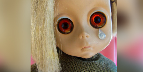 A creepy doll with large eyes