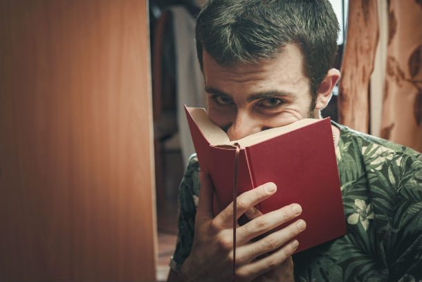 man smelling a book